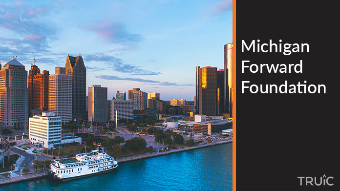 Cityscape of Detroit Michigan at sunset with text reading Michigan Forward Foundation