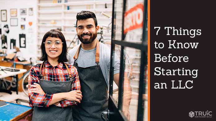 Two bike shop business owners standing in their store.