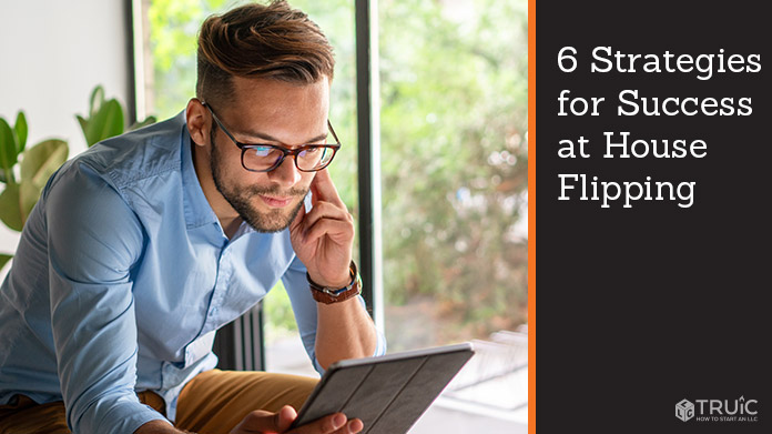 Man doing research on tablet for houses to flip.