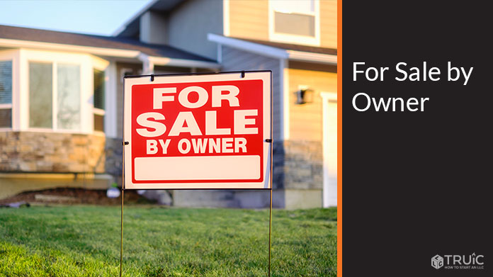 For sale by owner sign in the front yard of a house.