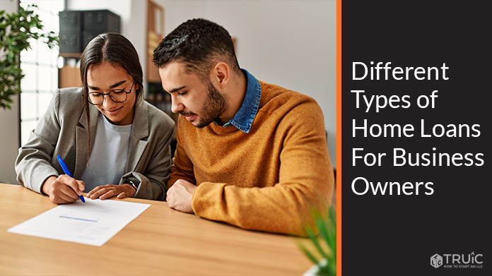 Couple signing a home loan document.