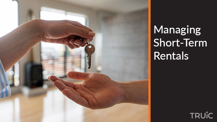 A person handing keys to another person.