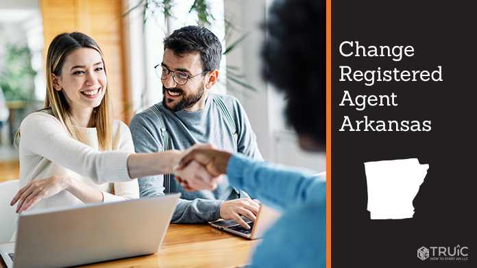 Couple meeting with registered agent, shaking hands.
