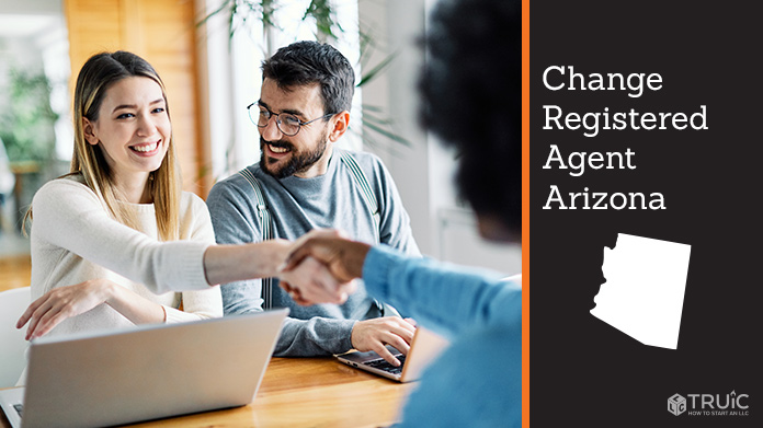 Couple meeting with registered agent, shaking hands.