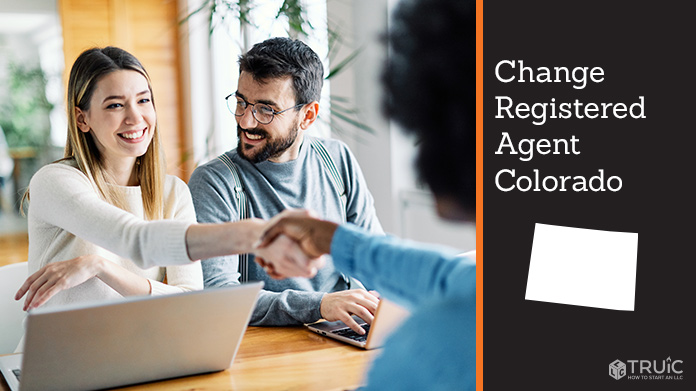 Couple meeting with registered agent, shaking hands.