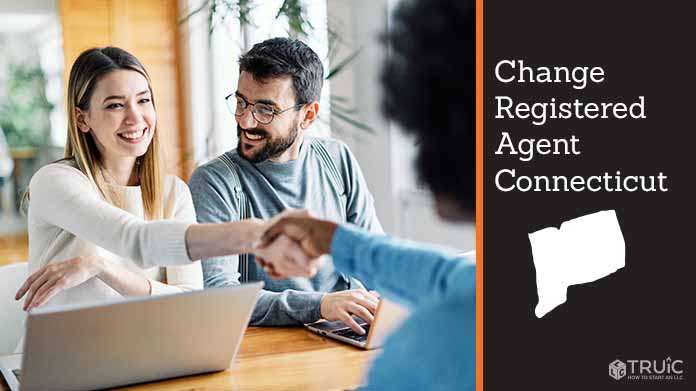 Couple meeting with registered agent, shaking hands.