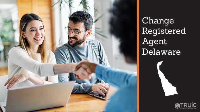 Couple meeting with registered agent, shaking hands.