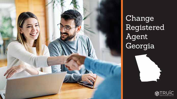 Couple meeting with registered agent, shaking hands.