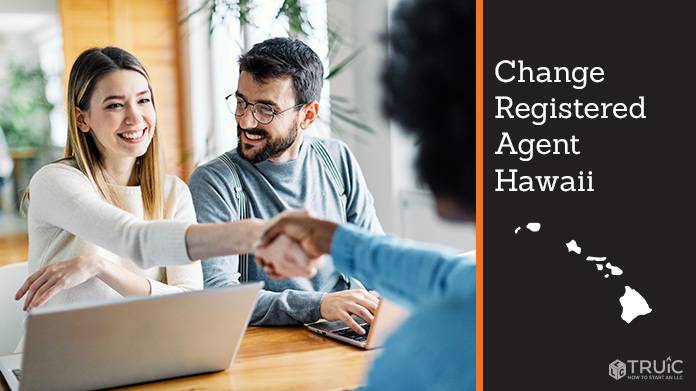 Couple meeting with registered agent, shaking hands.