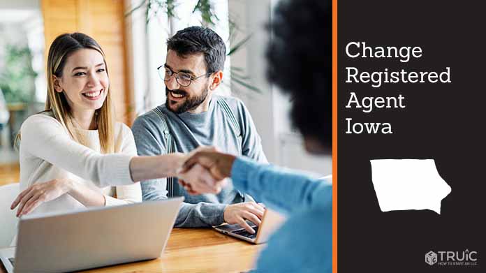 Couple meeting with registered agent, shaking hands.