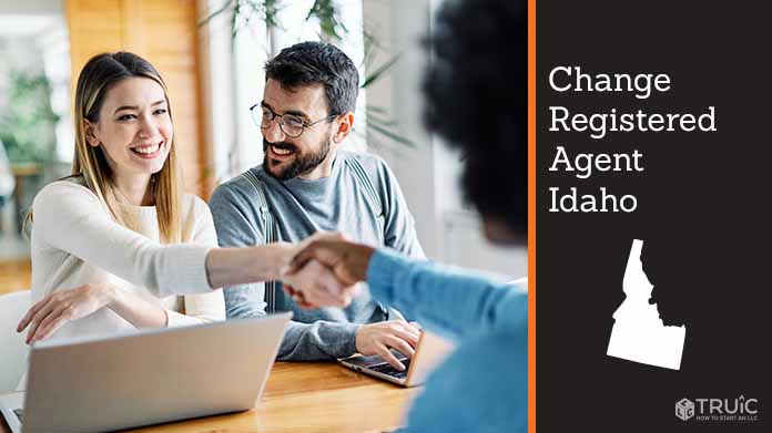 Couple meeting with registered agent, shaking hands.