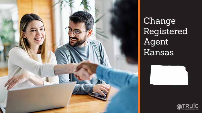 Couple meeting with registered agent, shaking hands.