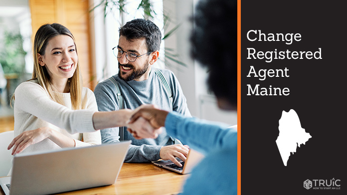 Couple meeting with registered agent, shaking hands.