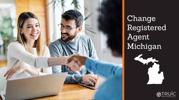 Couple meeting with registered agent, shaking hands.