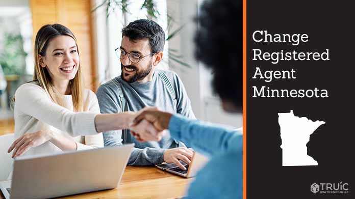 Couple meeting with registered agent, shaking hands.