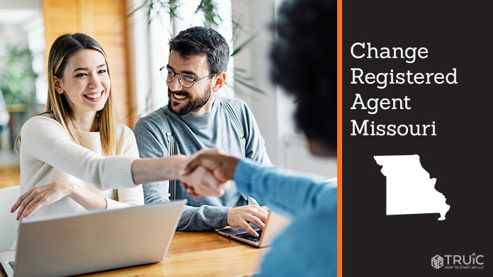 Couple meeting with registered agent, shaking hands.