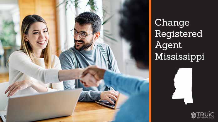 Couple meeting with registered agent, shaking hands.