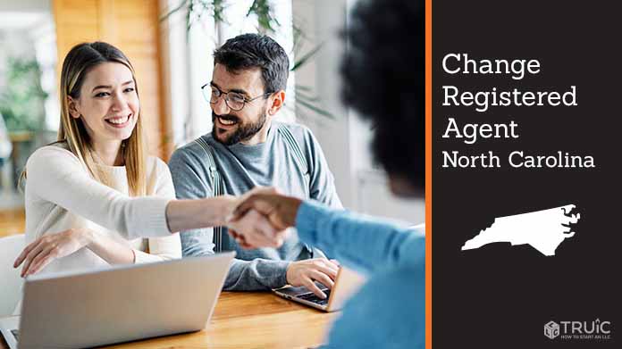 Couple meeting with registered agent, shaking hands.