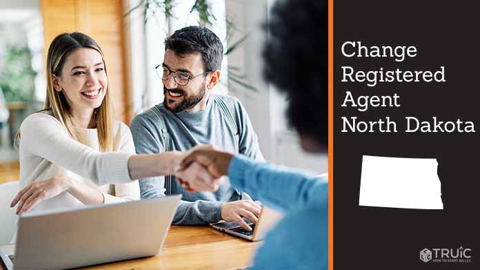 Couple meeting with registered agent, shaking hands.