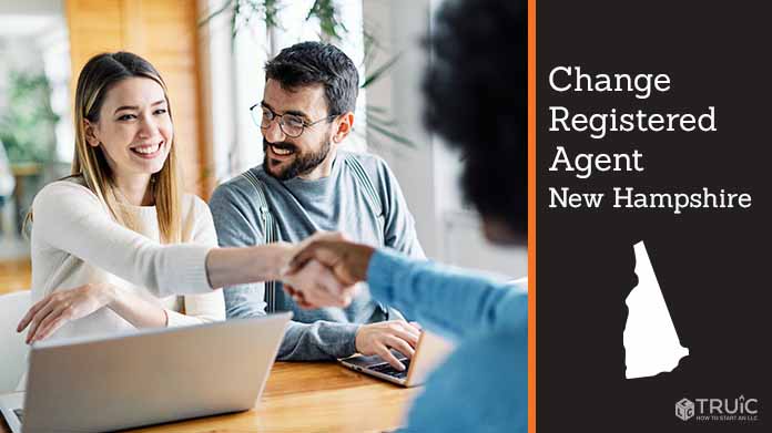 Couple meeting with registered agent, shaking hands.