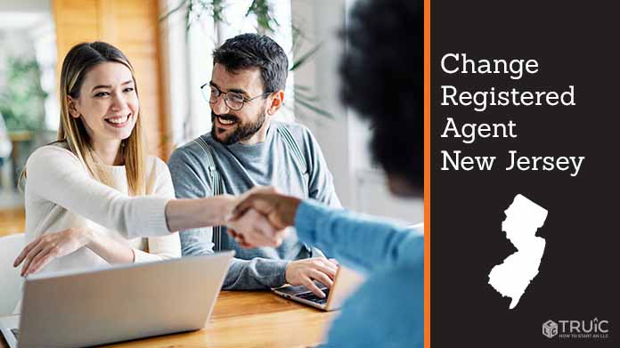 Couple meeting with registered agent, shaking hands.