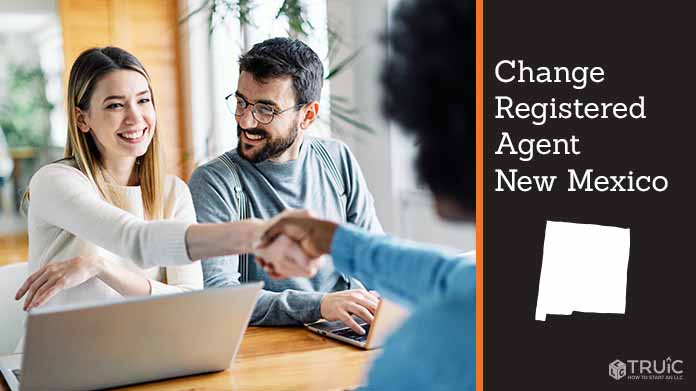 Couple meeting with registered agent, shaking hands.