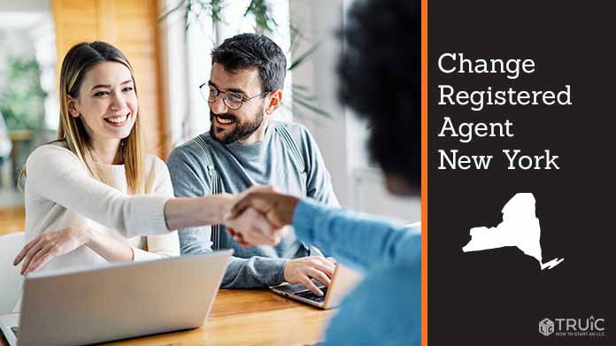 Couple meeting with registered agent, shaking hands.
