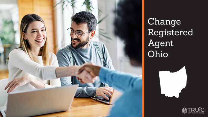 Couple meeting with registered agent, shaking hands.