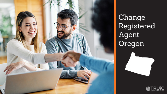 Couple meeting with registered agent, shaking hands.