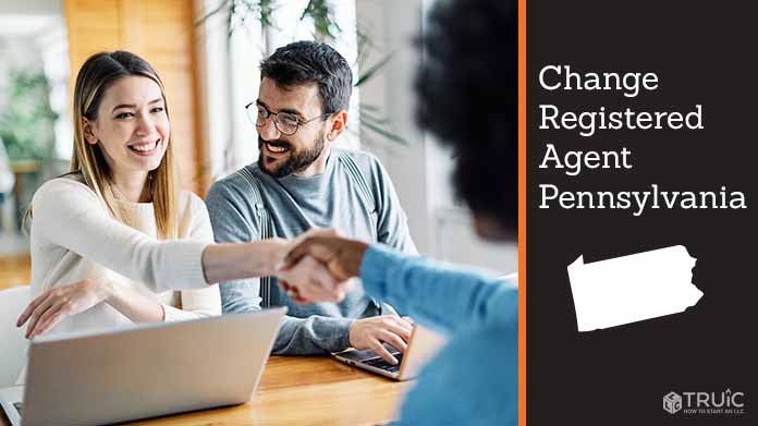 Couple meeting with registered agent, shaking hands.