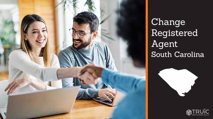 Couple meeting with registered agent, shaking hands.