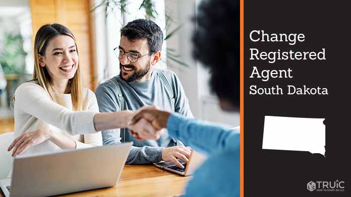 Couple meeting with registered agent, shaking hands.