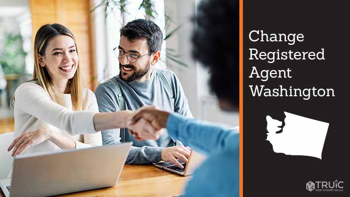 Couple meeting with registered agent, shaking hands.