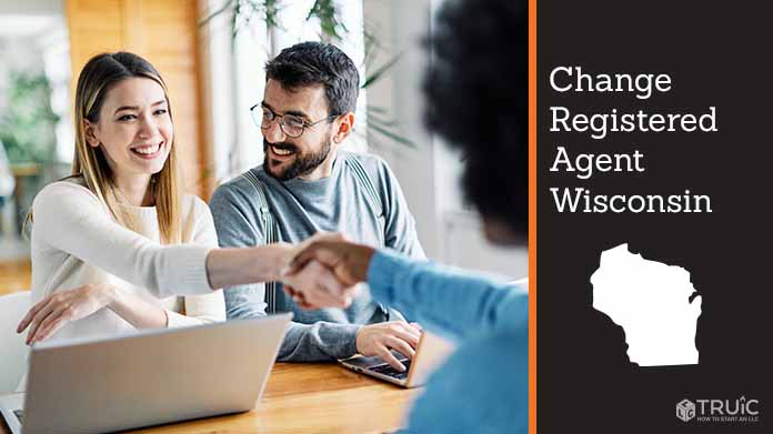 Couple meeting with registered agent, shaking hands.