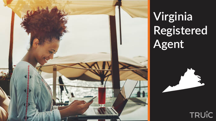 A person happily working remotely at a beach while their registered agent service takes care of business