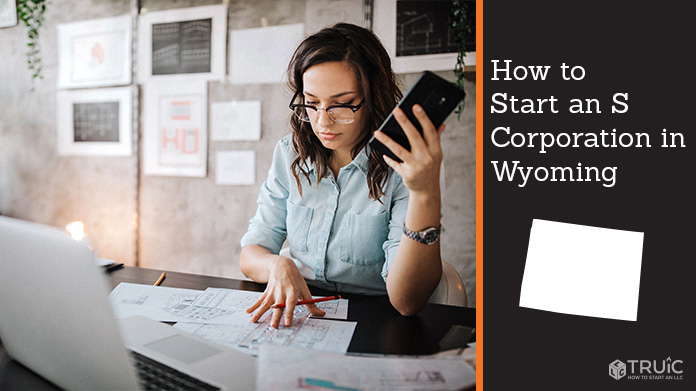 Woman looking over paperwork to start an S corporation in Wyoming