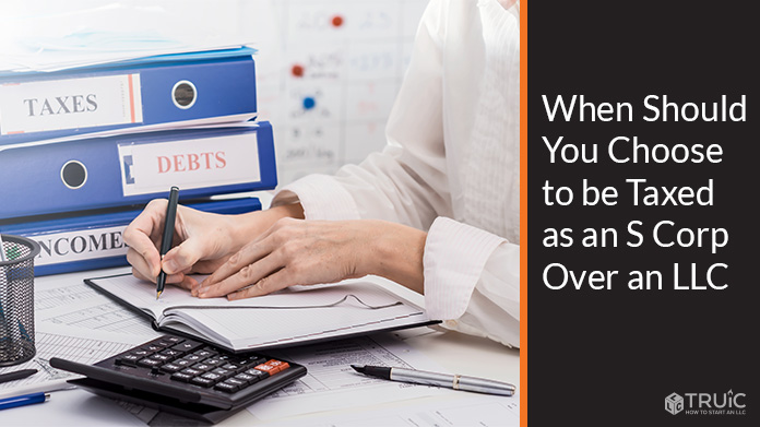 Entrepreneur writing tax calculations for S Corp in a journal