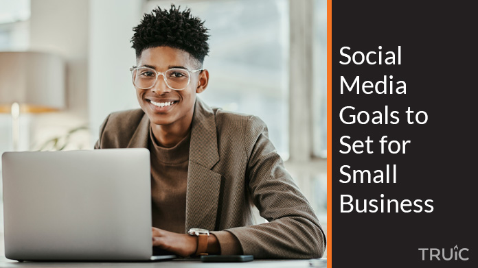 Man on computer looking at his social media goals for his small business.
